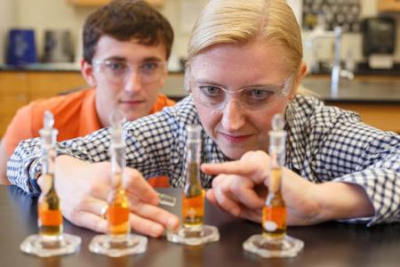 Chemistry professor with student looking at water samples for analysis